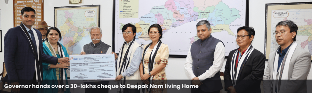 Governor hands over a cheque to Deepak Nam living Home